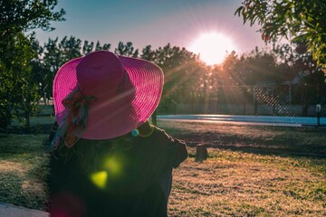 Woman in pink hat watching the sunrise