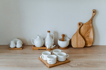 white tea set is in the kitchen, kitchen utensils, four cups