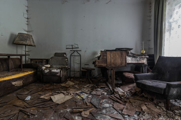 piano chair and a lamp on a disolved floor