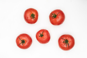 fresh tomatoes on a white background and summer vegetables