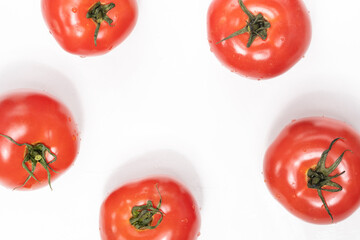 fresh tomatoes on a white background and summer vegetables