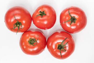fresh tomatoes on a white background and summer vegetables