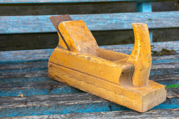 Old wooden jointer on old wooden boards. The concept of wood processing and manual work.