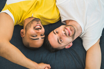 Gay couple laying down on the floor.