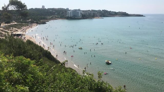 Salou, Spain, A flock of seagulls standing next to a body of water