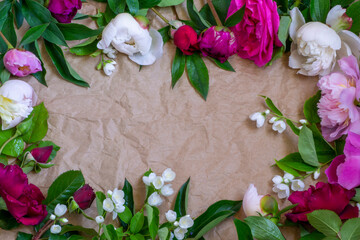summer bouquet of peonies, roses and jasmine on a craft background