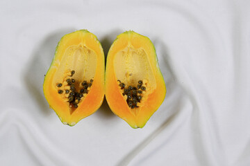 Fresh ripe sweet sliced papaya fruit isolated on white cloth background