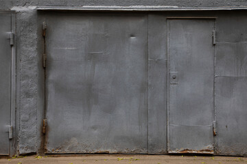 grey iron wall with door