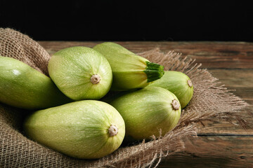 White zucchini on a wooden background, layout for a healthy diet and organic advertising of restaurant cooking