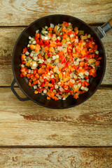Frozen vegetables on a wooden table in a pan.