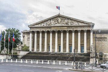 Fototapeta premium Bourbon Palace (Palais Bourbon, 1724) - palace located on Seine left bank, across Place de la Concorde in Paris. Bourbon Palace - seat of French National Assembly (inscription: Assemblee Nationale).