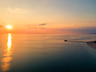 Aerial view of sunset over the sea in Palanga, Lithuania. Sandy coastline with the bridge to the sea.