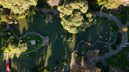 An aerial top-down view on Japanese styled garden with oriental architecture accents with the green...