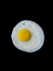 fried egg on black background