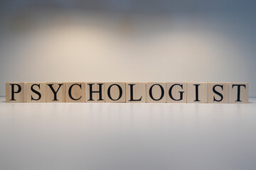 Psychologist text from wooden cubes. The term psychology profession.