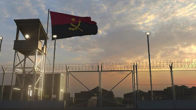 National flag of Angola above military base at sunset