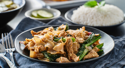 thai pad see ew with pork and chinese borccoli on plate