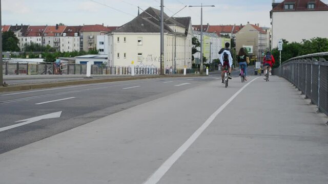 Cyclists passing on a bridge in Leipzig, Germany