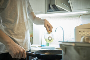 domestic cooking. caucasian male person cooking at kitchen. making keto meal. stew chicken fillet with vegetables such as onion and carrot. authentic.