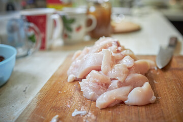 domestic cooking. caucasian male person cooking at kitchen. making keto meal. stew chicken fillet with vegetables such as onion and carrot. authentic.