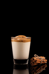 Dalgona coffee - the Korean coffee drink on black background. Instant coffee or espresso powder whipped with sugar and hot water. Iced whipped dalgona coffee concept