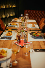 Table with prepared dinner in restaurant.