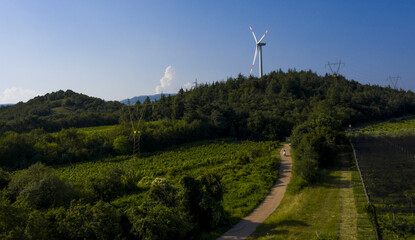 Aerial view of Wind turbine on the mountain to produce renewable electric energy. Drone