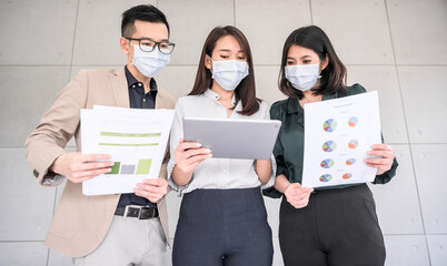 Asian business people wears face mask discuss project