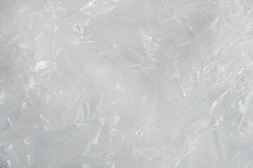 Wrinkled transparent plastic texture on a white background. Transparent packaging film. Top view....