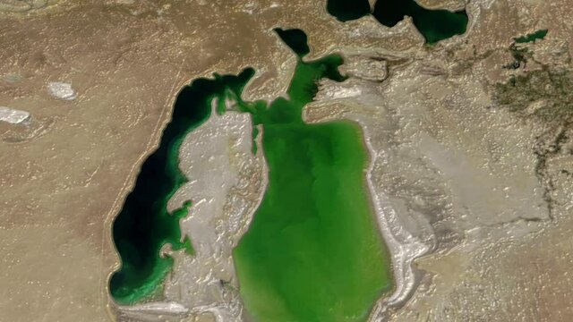 Flying on Aral sea lake drought time lapse aerial satellite view environmental earth, Aral sea located in Kazakhstan.  Images furnished by Nasa