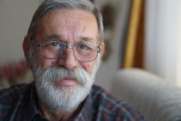 Portrait of a handsome senior man with beard smiling.