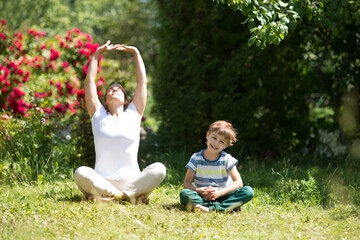 Family  mother and  son preschool child practice Tai Chi Chuan in a park.  Chinese management skill Qi's energy. solo outdoor activities. Social Distancing 