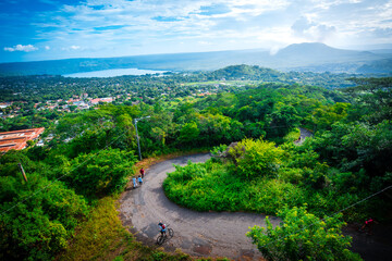 Lagoon, volcano and city landscape, with tourist pedestrian path in the foreground. Panoramic view from the 