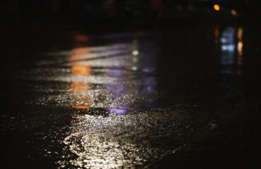Rainy night in the city,  view from the level of asphalt.