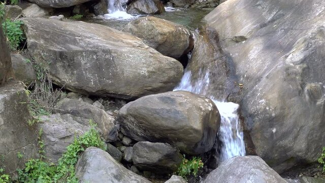 Closer view of waterfall passing through rocks. Footage shot at Jhalong, Dooars, West Bengal - India.