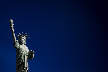 USA Independence Day. Statue of Liberty on blue background with copy space.