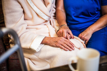 hands of an elderly patient with their nurse 