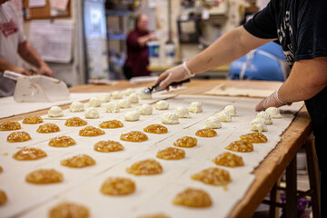 hands of a baker preparing pastries at a bakery shop