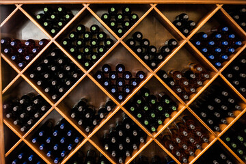 bottles of wine on a rack at a winery