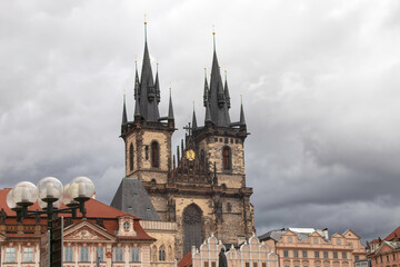 Fototapeta na wymiar Prague Old Town Church Our Lady of Tyn dark clouds streetlight in foreground nobody