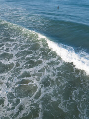 Aerial photo of waves breaking near a rural surf beach, New Zealand. 