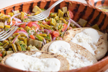 Mexican dish with tlacoyos and nopales (cactus)