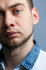 Obraz premium Closeup portrait of a man in a white polo on a white background. Male image for every day. Stylish guy
