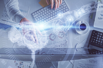Double exposure of man's hands typing over computer keyboard and brain hologram drawing. Top view. Ai and data technology concept.