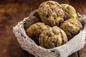 small homemade bread, biscuit called Broa or broinha, bread made from corn, on a rustic wooden background.