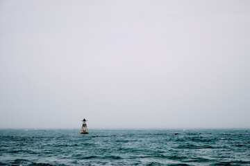 A shot of a buoy in the morning fog