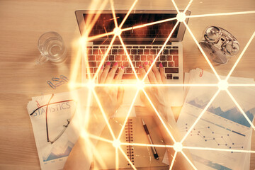 Double exposure of woman hands working on computer and social network theme hologram drawing. Top View. People connection concept.