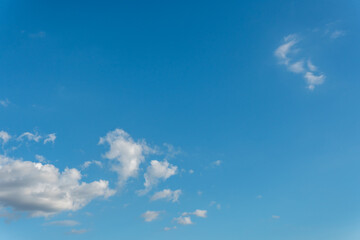 Blue sky background with small cloud.
