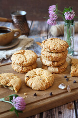 Oatmeal cookies with chocolate drops, cezve and cup of coffee