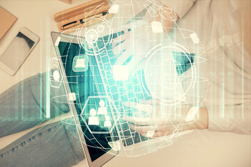 Double exposure of woman hands working on computer and social network theme hologram drawing. Top View. People connection concept.